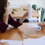 budowa piramidy z plastikowych kubków i kartek papieru zwiniętych w rulon